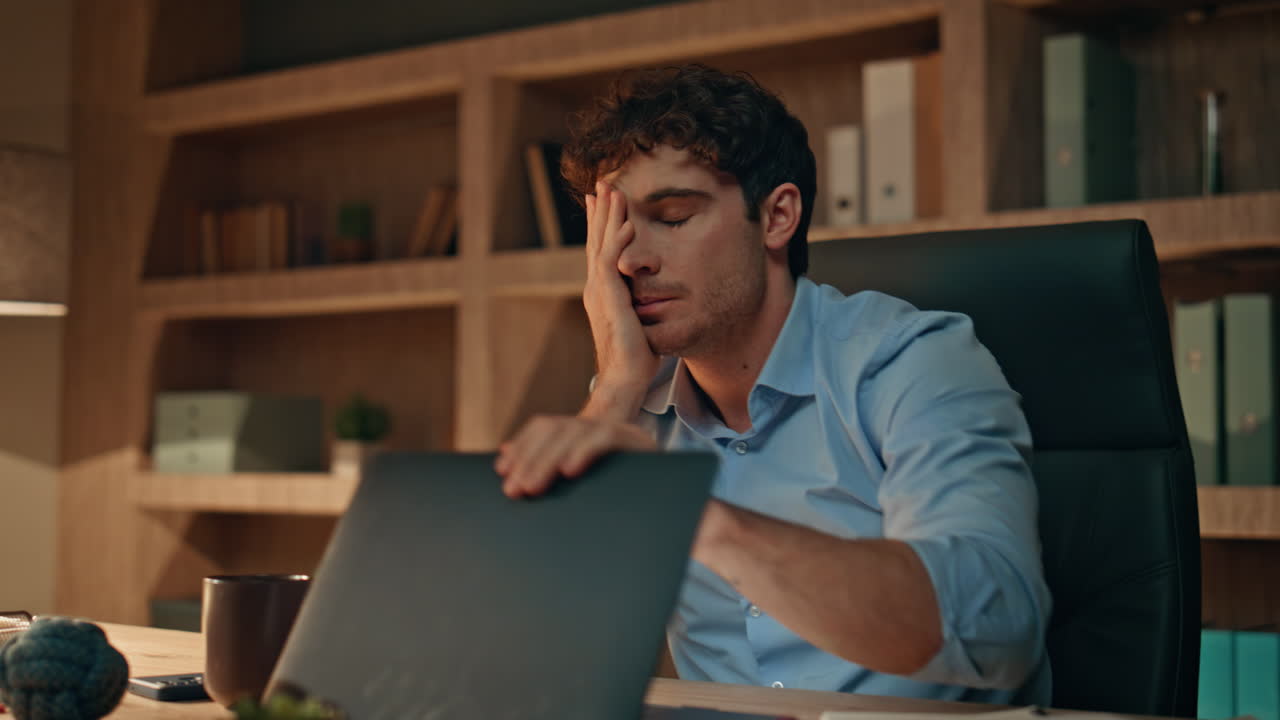 Overloaded manager thinking work sitting night office closeup. Tired businessman