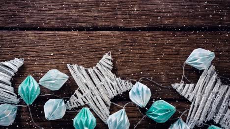 falling snow with christmas decorations on wood