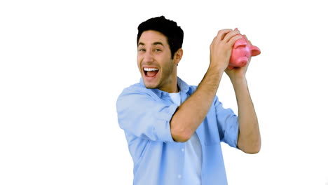 Man-shaking-piggy-bank-excitedly-on-white-background