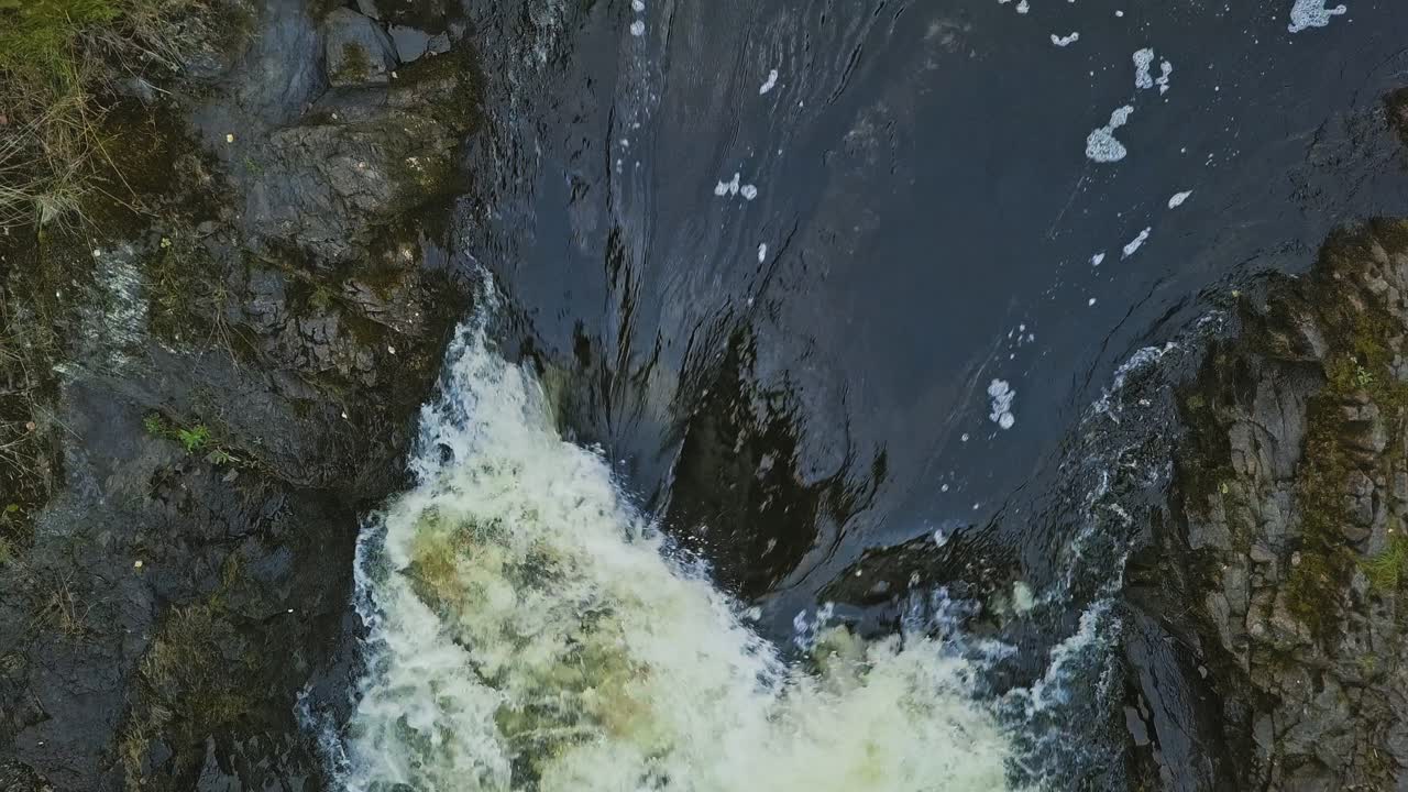 Aerial footage of a Karelian waterfall Kivach, full water stream over the top, beautiful nature, foam on water