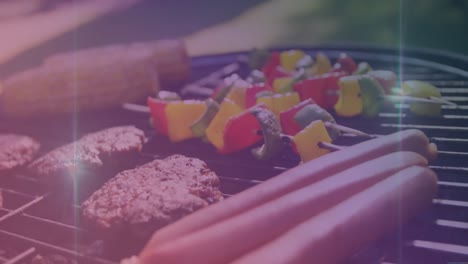 animación de puntos de luz sobre la carne y las verduras en la barbacoa