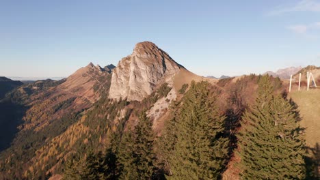 drone flying away from trees on high mountain summit