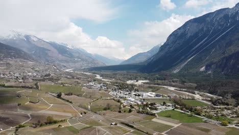 the-small-town-of-Salgesch-in-a-picturesque-swiss-Valley,-with-nice-sunny-weather,-by-drone