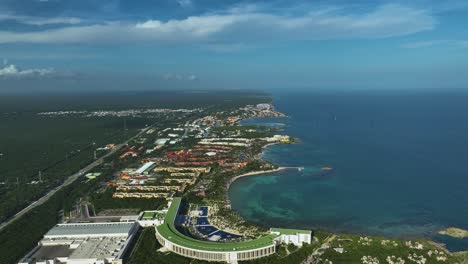 aerial view over hotels on the coastline of xpu-ha, mayan riviera, mexico - pull back, drone shot