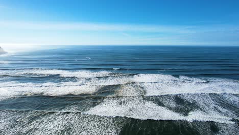 4k aerial drone shot floating overlooking seaside, oregon ocean on a sunny day