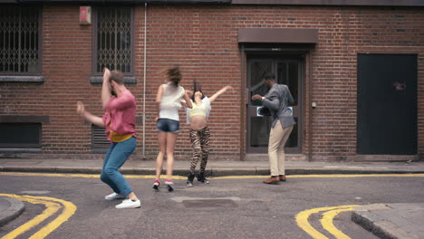 group of multi-racial dancers street dancing funky freestyle in the city