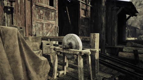 Wooden structure with a round object in a rustic setting during the day