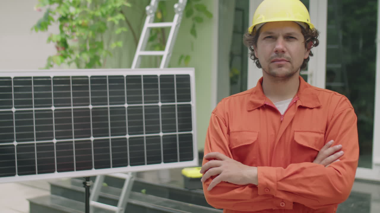Portrait of Worker in Hardhat beside Solar Panel Outdoors