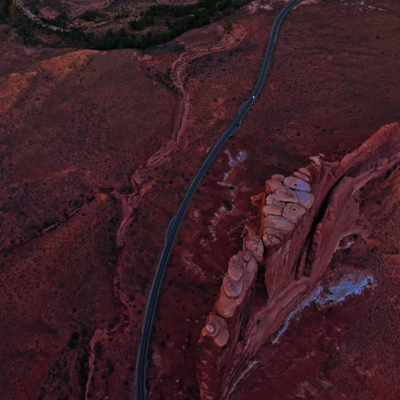 Long speed road going through a wild dessert landscape. Drone flying high above the plain in Zion canyon, Utah, USA