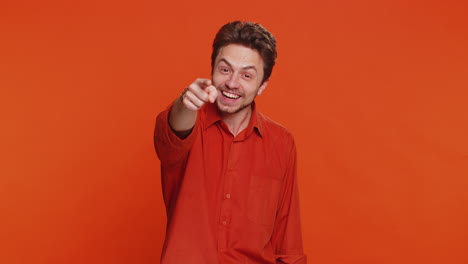 happy caucasian smiling man pointing finger to camera making winner choice showing direction select
