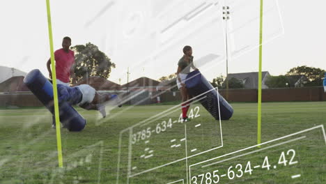 football players practicing with tackling dummies on field, data overlay animation