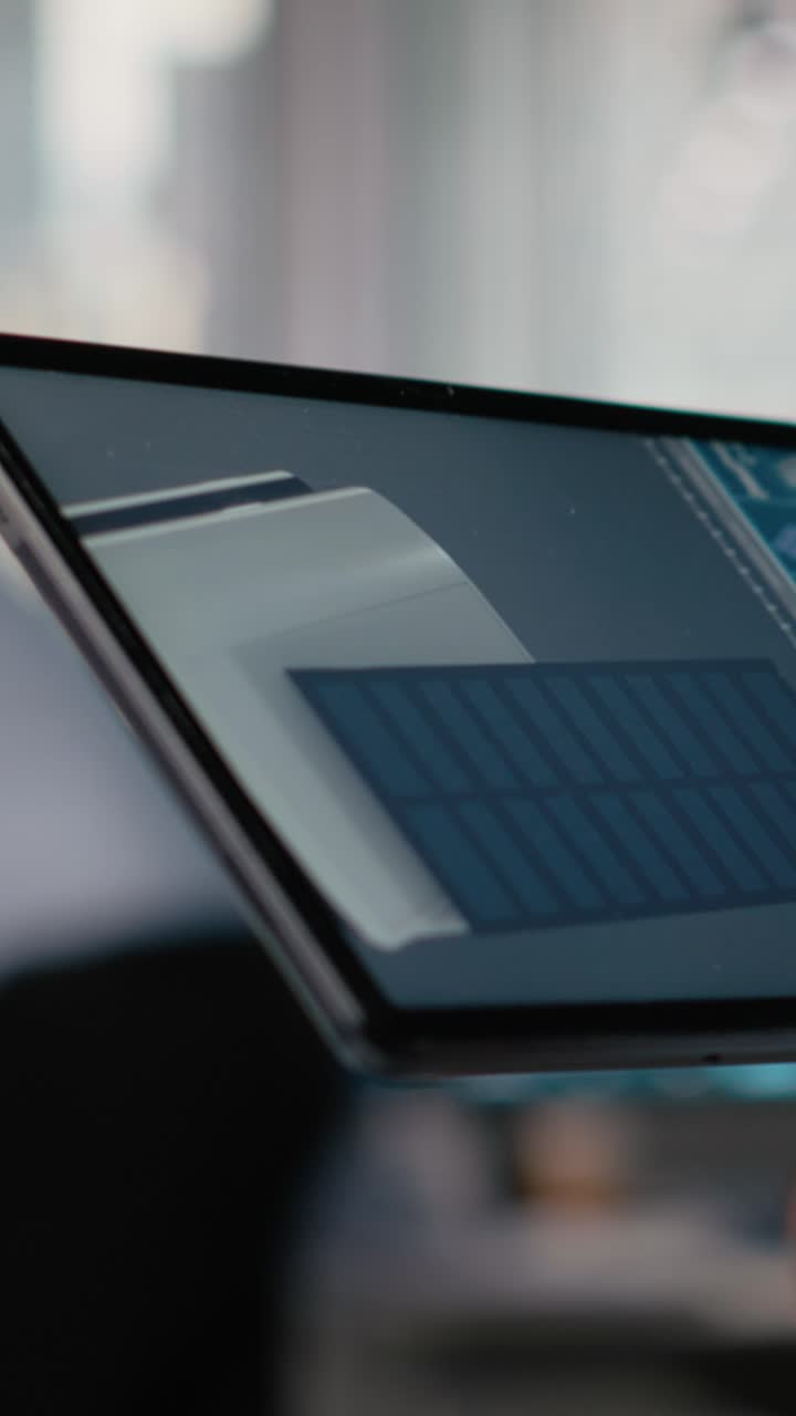 Close up of RD office employee uses touchscreen device, creating eco solar gadget