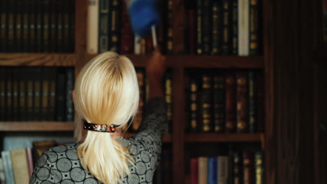 librarian cleaning bookshelves