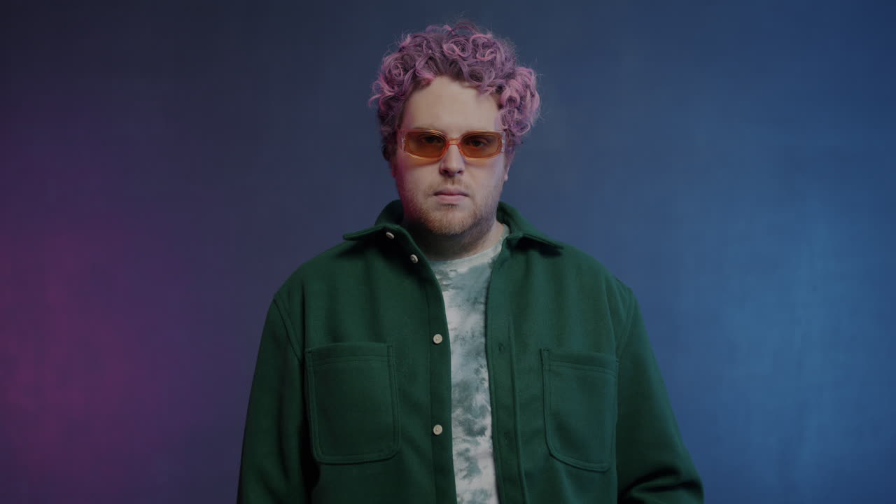 Stylish Man with Pink Hair and Green Jacket