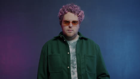 stylish man with pink hair and green jacket