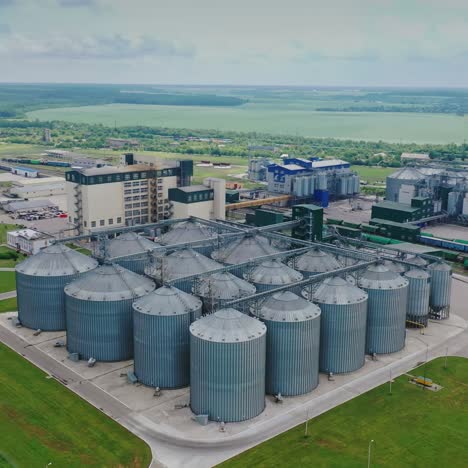 agribusiness. elevator for grain storage. exterior of steel containers on the manufacturing on nature background. aerial view.