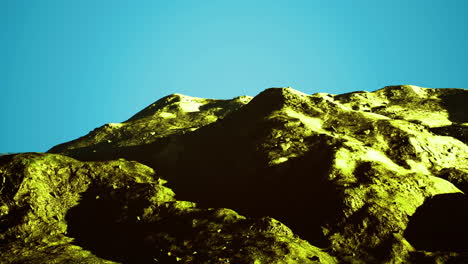 dramatic mountain landscape captured under a vibrant blue sky at midday