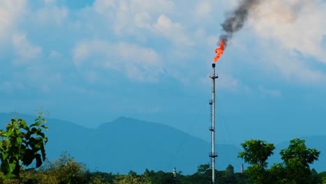 a gas field in bangladesh, surrounded by hills and forested areas, highlighting environmental impact