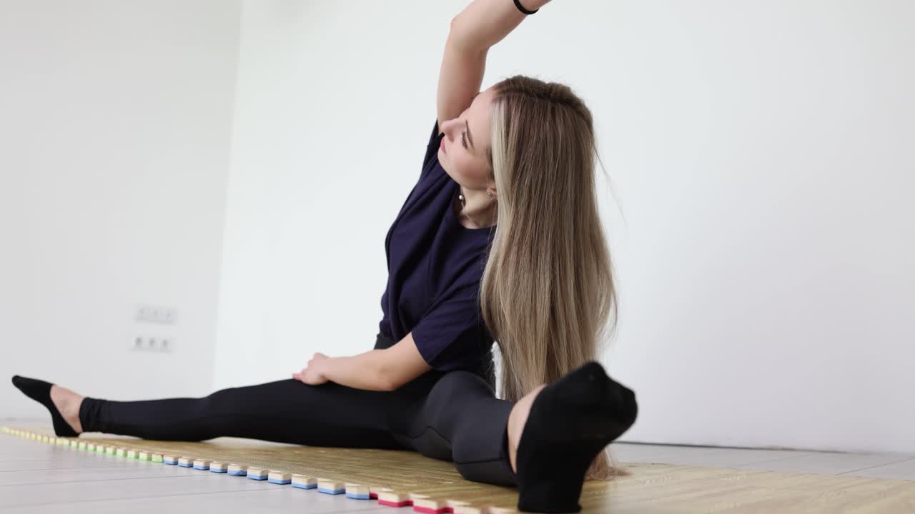 Woman doing yoga split exercise