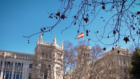 detail shot of the spanish flag on the rooftop of the naval museum on paseo del prado in madrid, spain