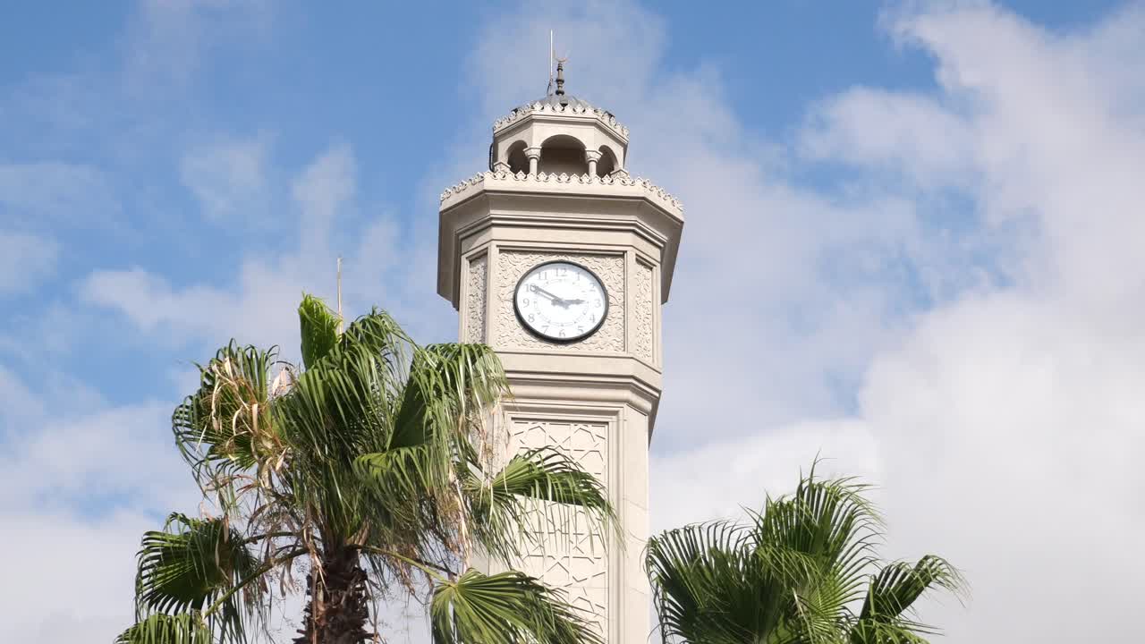 Clock Tower in a Sunny Day with Palm Trees