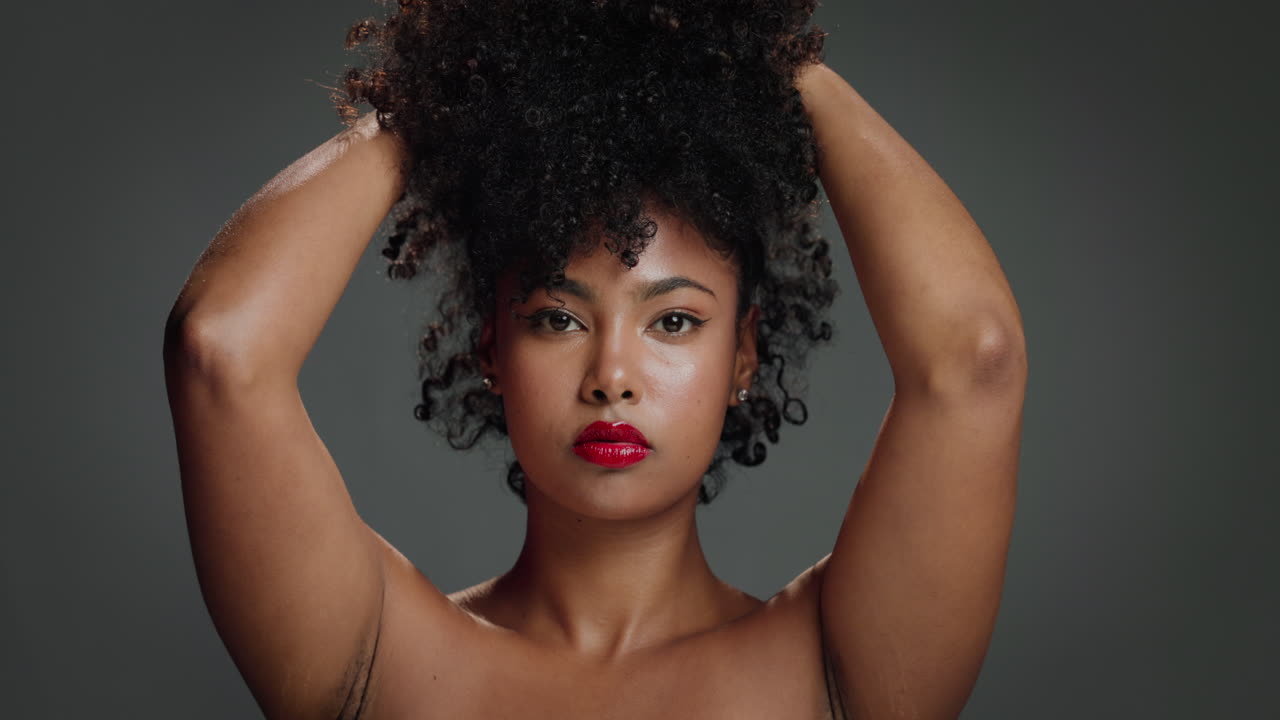 Portrait of a beautiful woman with afro hair and red lipstick
