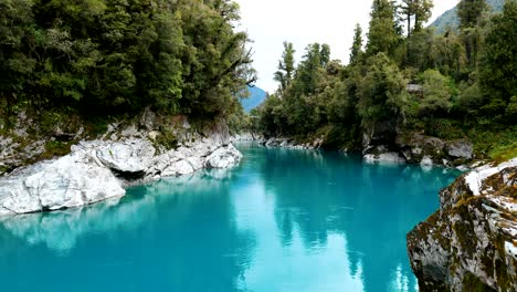 spectacular wide shot capturing the dynamic flow of water through hokitika gorge, a mesmerizing display of nature's power