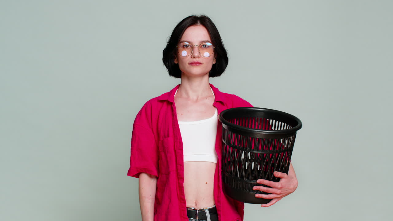 Young woman smiling removing eyeglasses throwing them away symbolizing vision correction and freedom