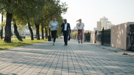business people walking and running in a park