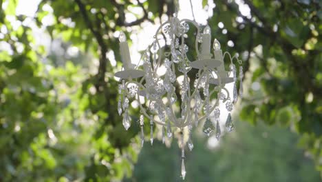 Elegant crystal chandelier. Outdoor wedding decoration. Zoom