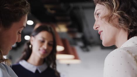 happy diverse female colleagues in discussion in casual office meeting, slow motion