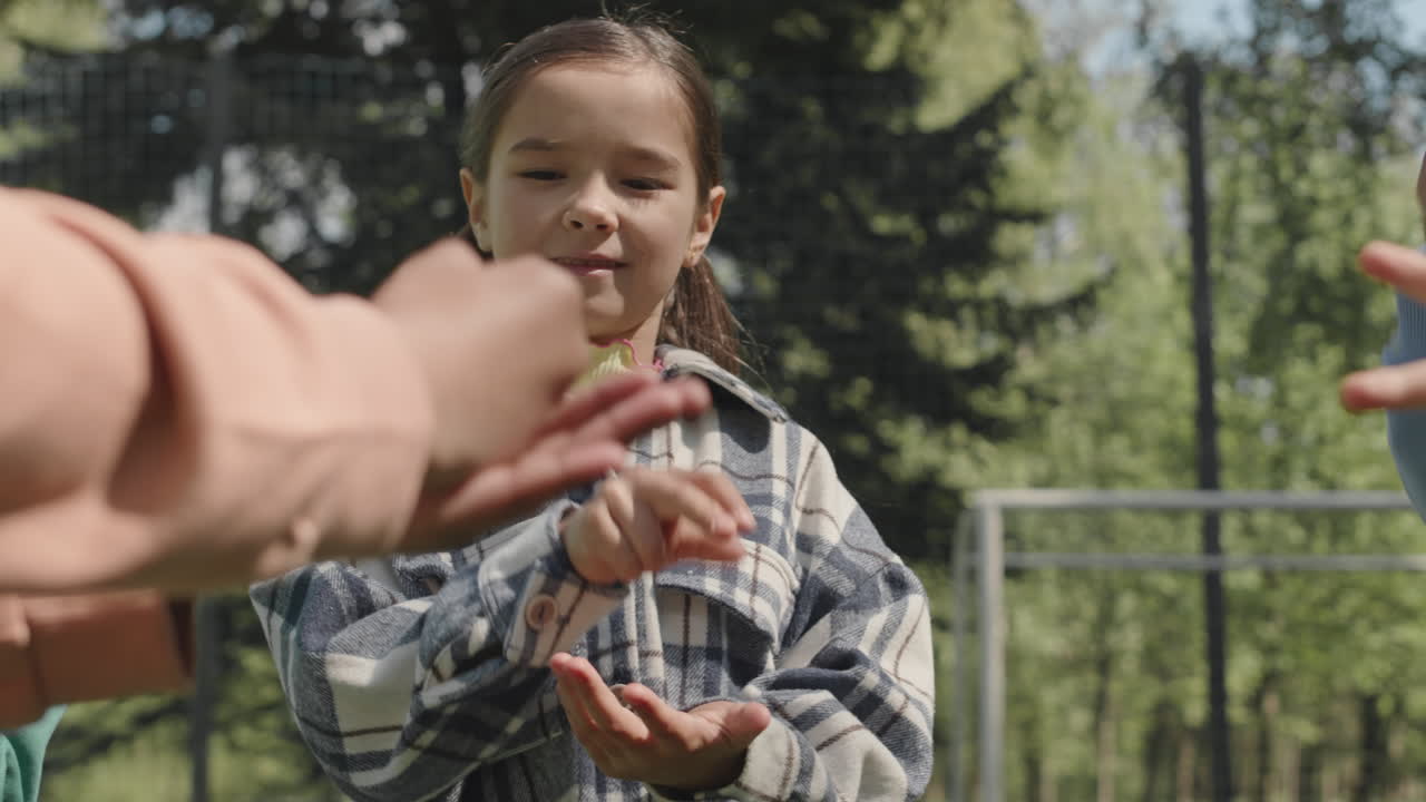 Little Boy Playing Hand Game with Friends Outdoors