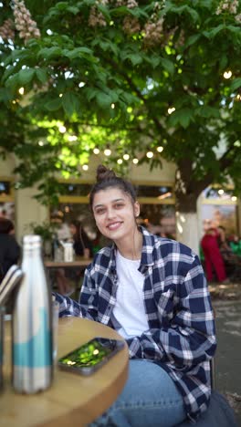 woman enjoying a drink in an outdoor cafe