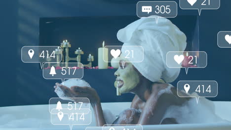 social media notifications animation over woman relaxing in bubble bath with candles