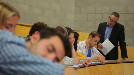 student napping in the lecture hall and then waking up