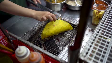 Toma-En-Cámara-Lenta-De-Taco-A-La-Parrilla-O-Quesadilla-En-Un-Puesto-De-Comida-Callejera,-Hoi-An,-Primer-Plano