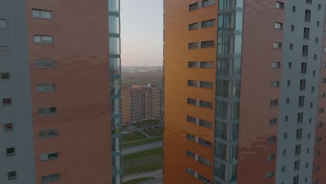 drone camera view a drone flies between two high-rise buildings on a sunny evening