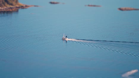 A-fishing-boat-crosses-the-fjord-leaving-for-an-open-sea