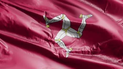 la bandera de la isla de man se agita lentamente en el bucle del viento. el estandarte de la isla del man se balancea suavemente en la brisa. fondo de relleno completo. bucle de 20 segundos.