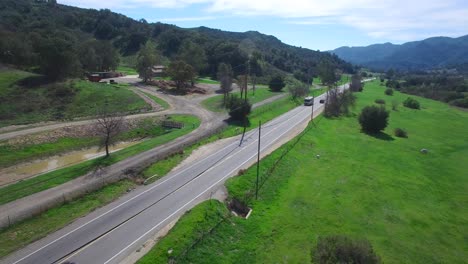 aerial of a motorhome traveling on a country road