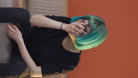 Vertical-video-of-Depressed-young-woman-covering-her-face-with-her-hand.