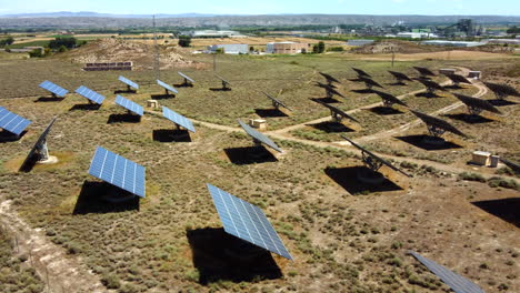 aerial view of solar panels farm in a desert place