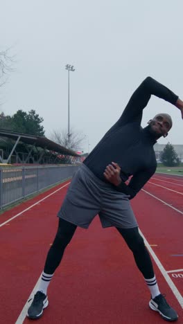 man stretching on a track