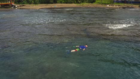 scuba diver snorkelling - breathing underwater, exploring panama island coastal shoreline