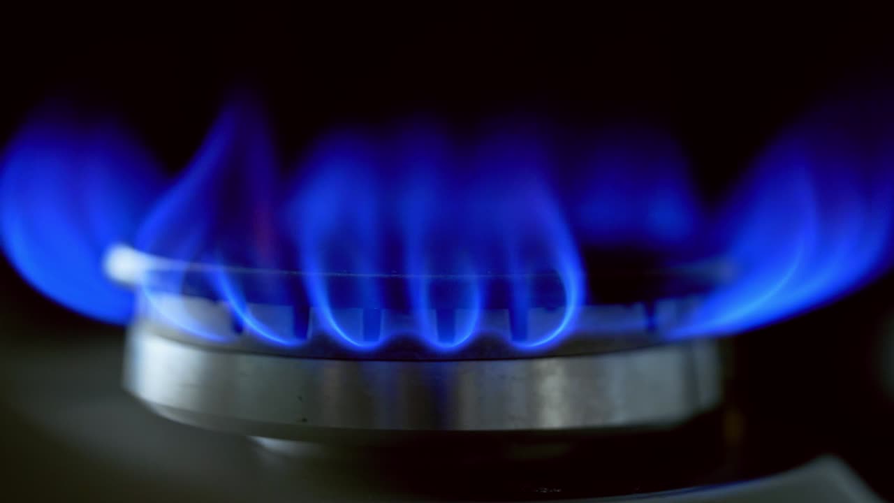 Flame of kitchen gas stove. Kitchen stovetop cook with blue flames propane gas burning