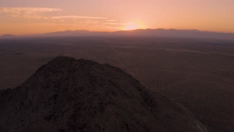 mojave desert mountains during fire sunrise or sunset in california, aerial pan