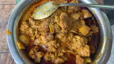 Close-rotating-shot-over-cauliflower-curry-with-potato-in-a-steel-bowl-before-been-served-at-a-function-in-India