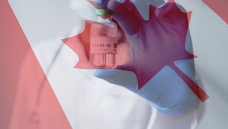 Animation-Der-Flagge-Kanadas-über-Einem-Arzt-In-Gesichtsmaske,-Der-Eine-Durchstechflasche-Mit-Covid-Impfstoff-Hält