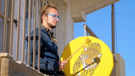 male musician relaxed playing native american drum percussion outdoors