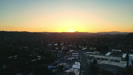 Peripheral-town-side-lightened-by-majestic-sun-rays,-city-surrounded-by-rich-forest